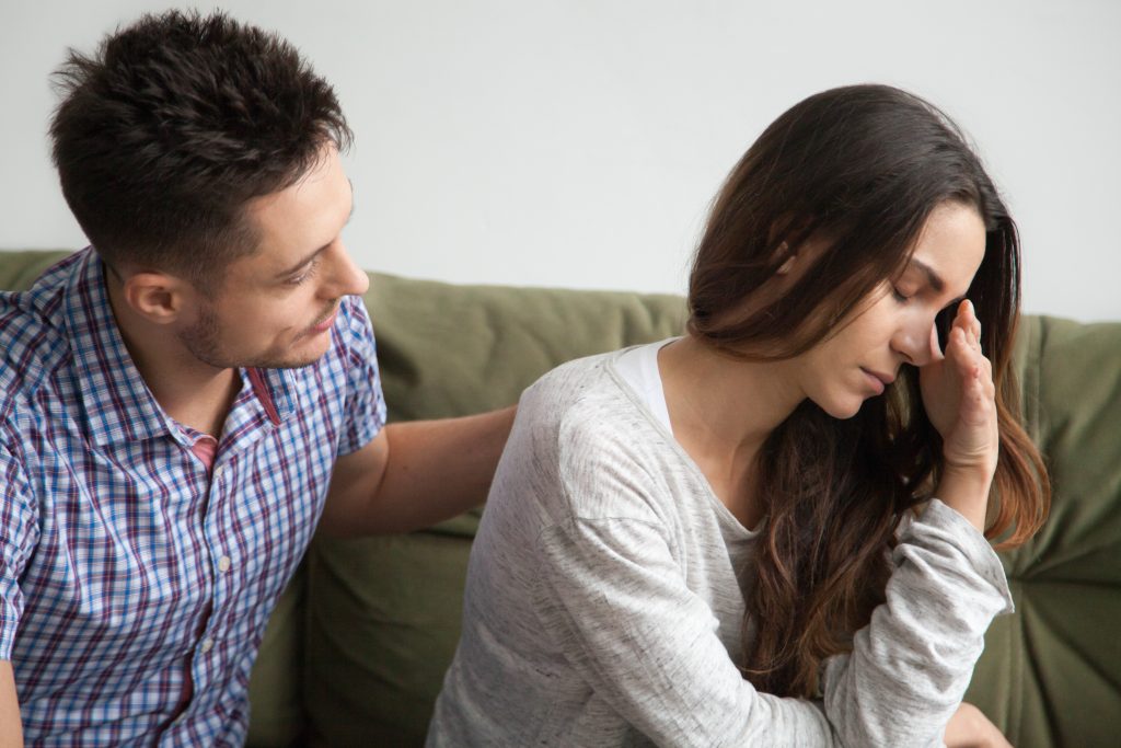 Caring husband apologizing crying upset wife excusing for being